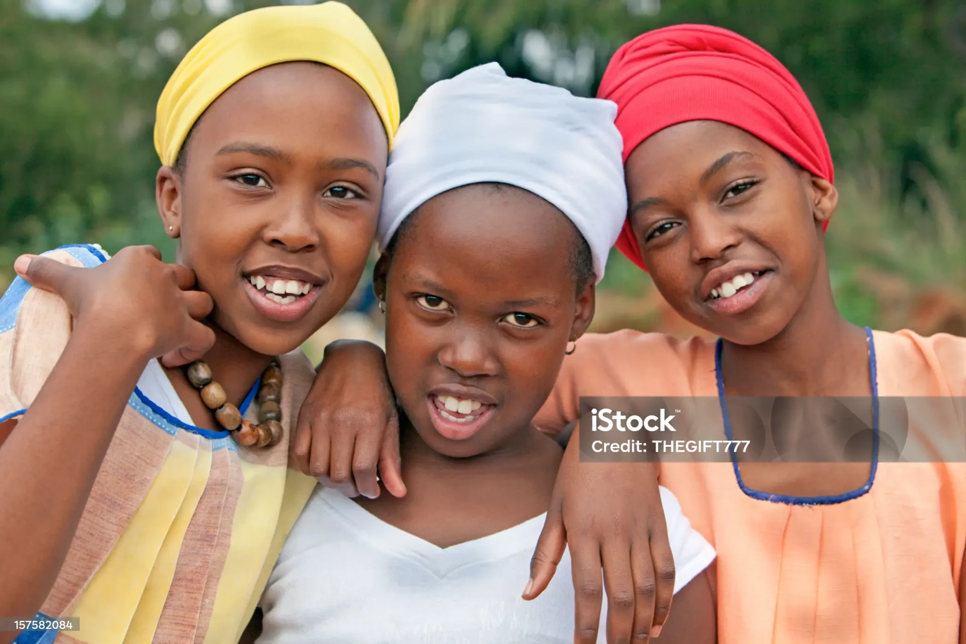 Three young girls smiling together